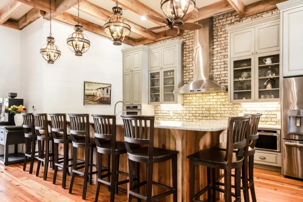 Beautiful farmhouse-style kitchen with ample countertop seating, stainless steel appliances, and a coffee bar