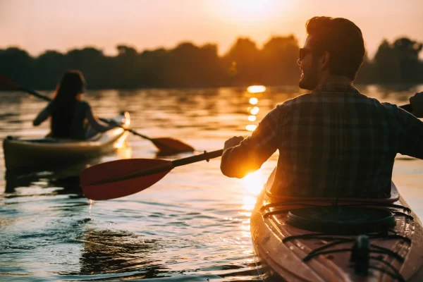 Two people kayaking at sunset